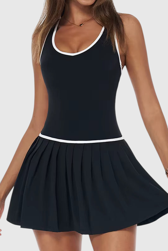 LUPPO black 2-in-1 athletic court dress with white contrast trim, pleated skirt, and racerback design on a model.