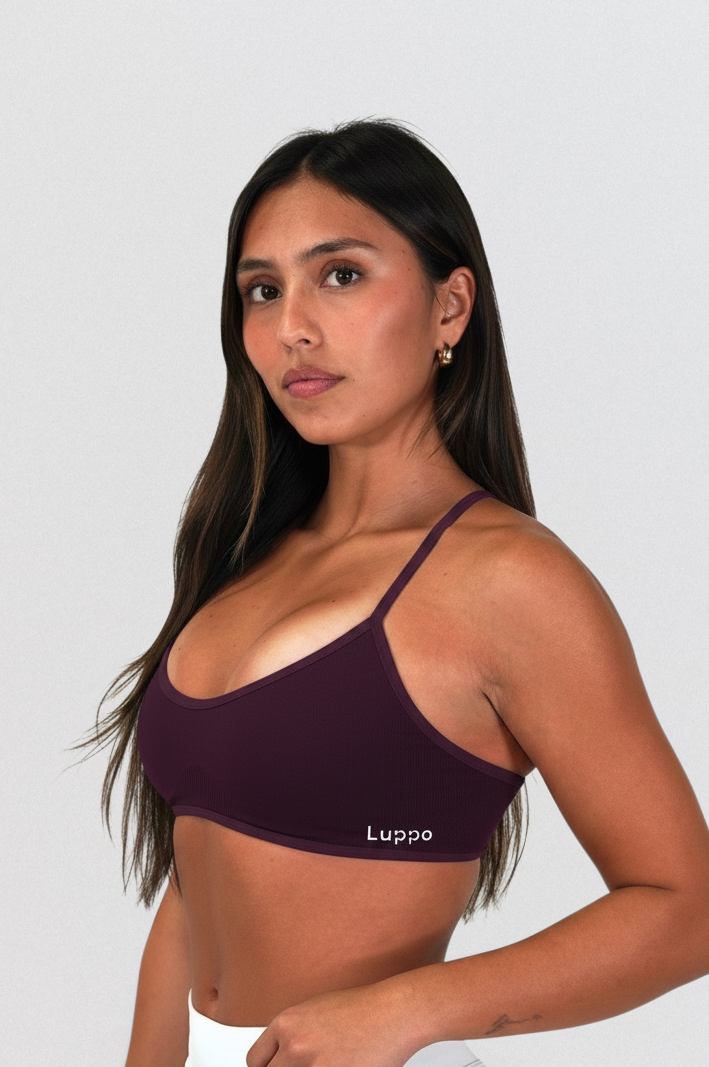 LUPPO backless training top in dark plum with adjustable spaghetti straps and elastic underband on a model