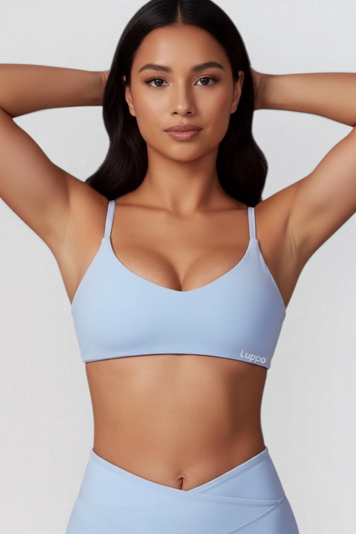 LUPPO light blue seamless scoop neck sports bra with adjustable straps and minimal branding. Made from a nylon/elastane blend.