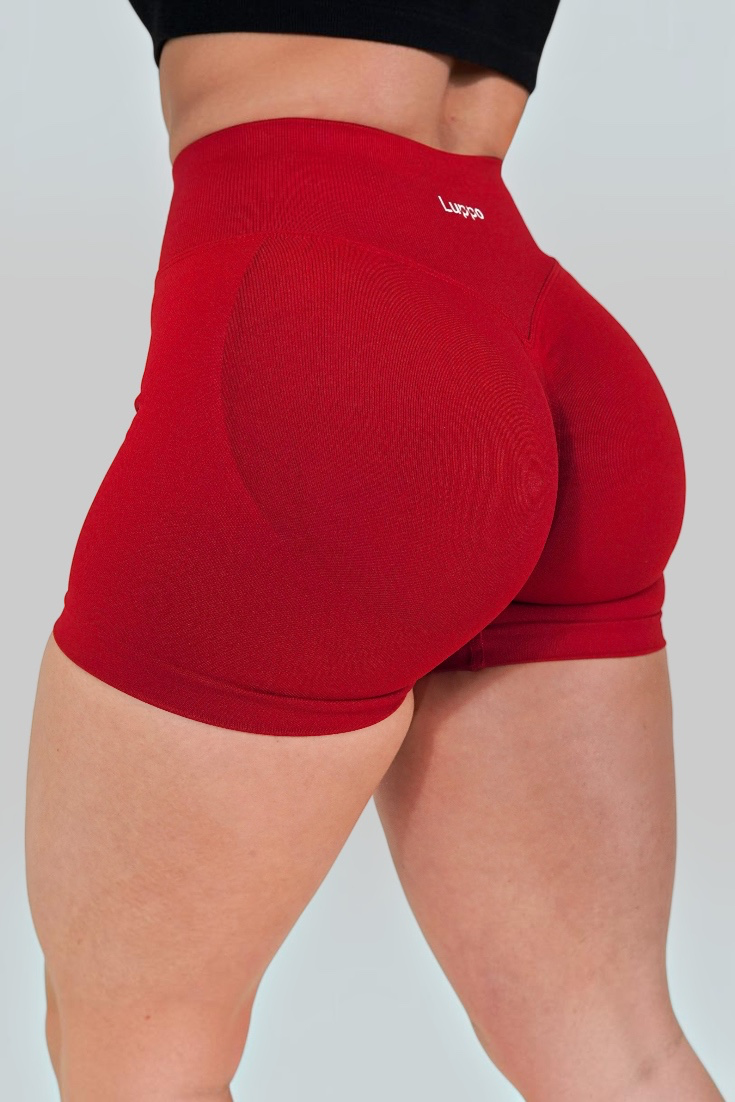 LUPPO Sculpt high-waist red athletic shorts with glute-contouring panels and a firm scrunch back detail.