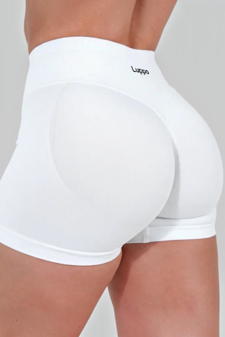 LUPPO white high-waist workout shorts featuring glute contouring panels and a wide waistband for a secure fit.